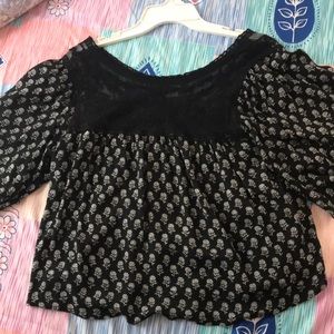 black blouse with shower print and a lace panel